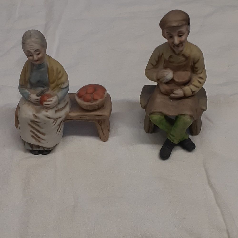 Pair of vintage ceramic figurines: old woman peeling apples and man scrubbing.‎